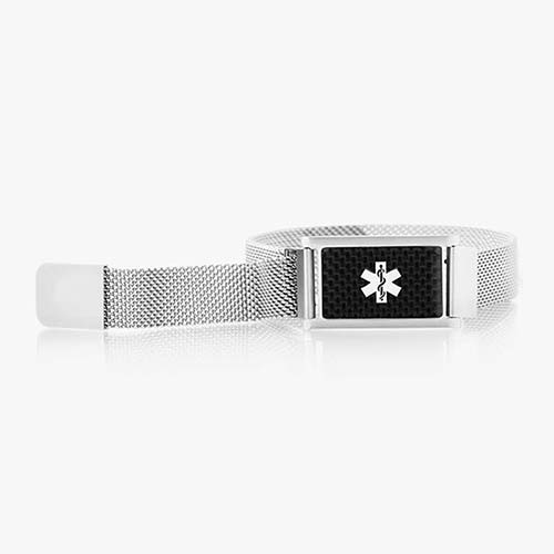 Front of stainless steel magnetic bracelet with silver mesh chain and affixed medical ID tag with silver caduceus on carbon fiber background