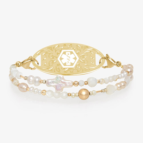 Beaded mother of pearl, white quartz, and gold tone beaded medical ID bracelet with gold tone oval cross med ID tag with white symbol.