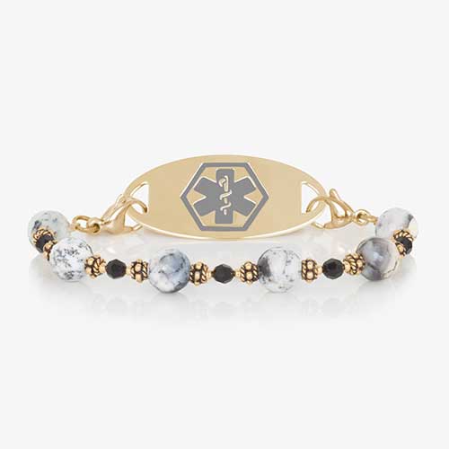 Dendritic opal, black crystal, and gold beaded medical ID bracelet paired with gold tone stainless steel medical ID tag with grey cadu gold tone medical symbol at the center.