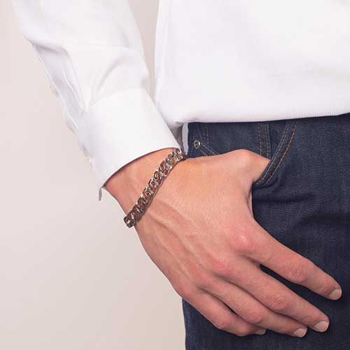 Man wearing medical ID curb chain with cedar wood inlay