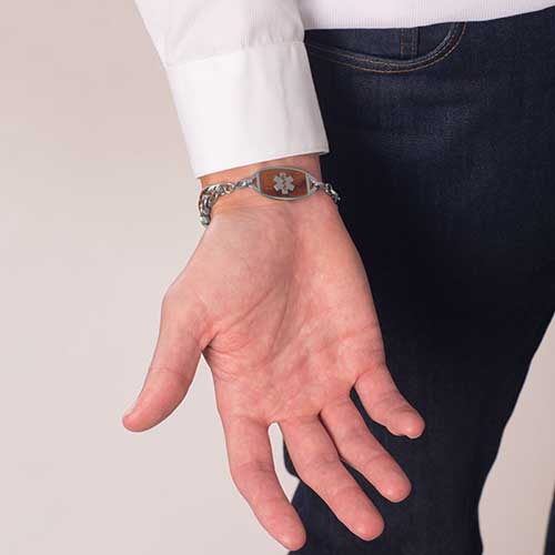 Man showing medical ID tag with cedar wood inlay