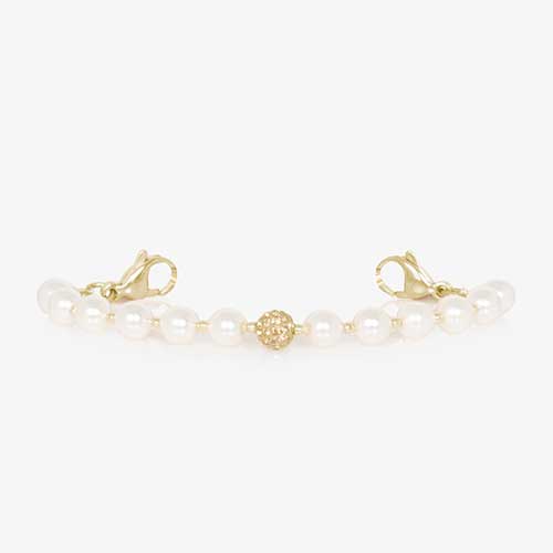 Pearl and gold tone stretch medical ID bracelet with sparkly gold tone centerpiece.