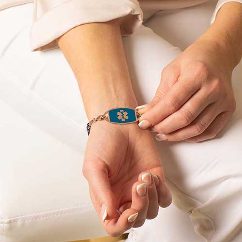 Woman showing Rose Gold and Sapphire Medical ID Tag
