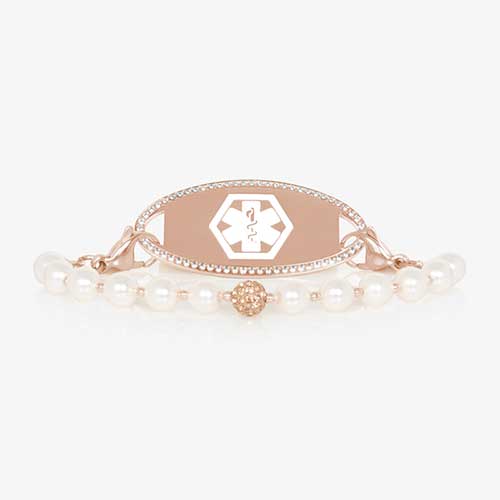 Pearl and rose gold tone stretch medical ID bracelet with sparkly rose gold tone centerpiece and rose gold tone stainless steel medical ID tag with a crystal border.