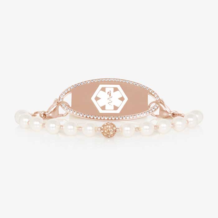 Pearl and rose gold tone stretch medical ID bracelet with sparkly rose gold tone centerpiece and rose gold tone stainless steel medical ID tag with a crystal border.