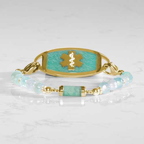 Green beaded medical ID bracelet with gold tone lobster clasps and Amazonite  decorative medical ID tag on white marble