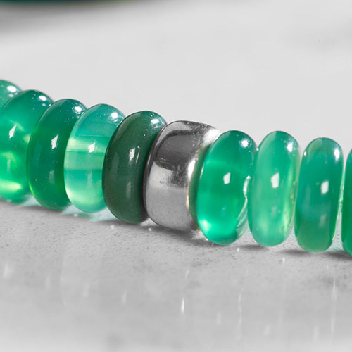 Close Up of Jade heishi beads and silver rondelle bead.