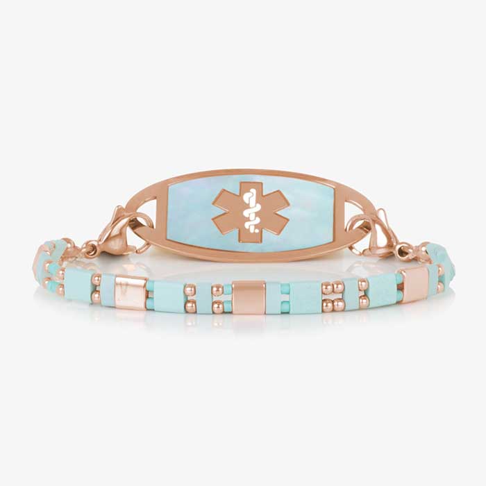 Stylish medical ID bracelet with an aqua and rose mother-of-pearl inlay, featuring an engraved medical alert emblem on a durable metal plate. Elegant and functional design for everyday wear.