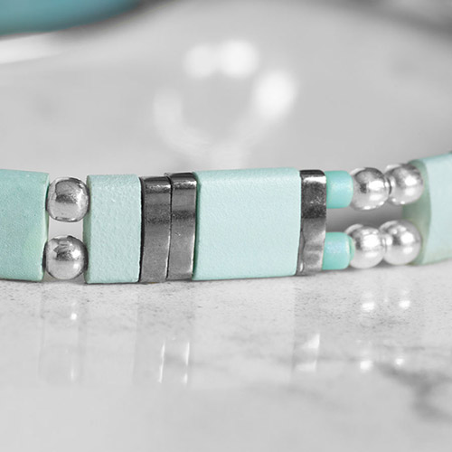 Stylish silver medical ID bracelet displayed flat, showcasing intricate design details and adjustable chain.