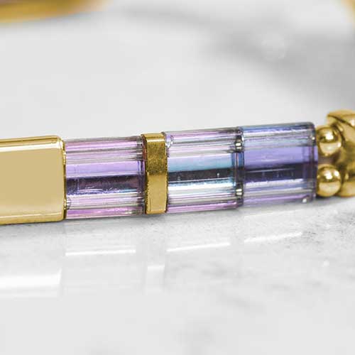 Close-up of iridescent pastel beaded strand with gold accents, designed for use with interchangeable medical ID tags.