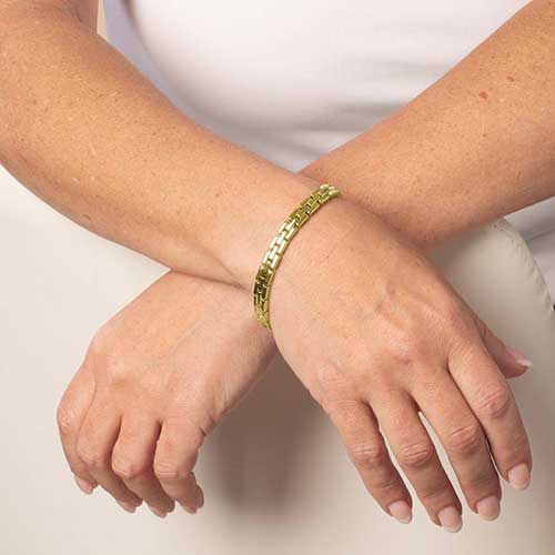 Woman wearing Gold tone, stainless steel Gate Link Chain bracelet.