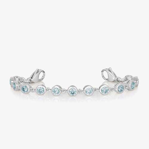 Rhodium and palladium plated women&#39;s medical alert bracelet with aquamarine tone, round, bezel set cubic zirconia crystals paired with stainless steel and mother of pearl medical ID tag.