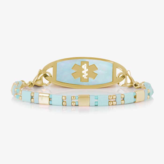 Stylish medical ID bracelet with an aqua and gold mother-of-pearl inlay, featuring an engraved medical alert emblem on a durable metal plate. Elegant and functional design for everyday wear.