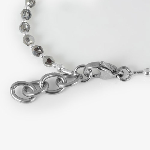 Detail view of the Lori bracelet clasp with round stretch cord and lobster clasp.