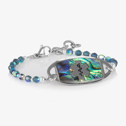 SmartStretch medical ID bracelet with abalone inlay and blue faceted beads, featuring silver lobster clasp and engraved tag.