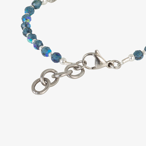 Close-up of silver lobster clasp and extender on blue SmartStretch medical bracelet with faceted beads.