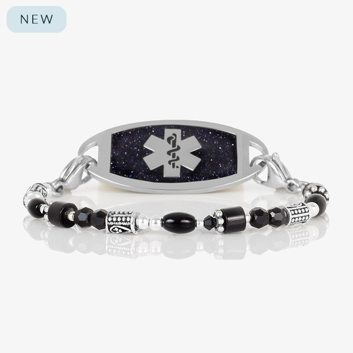 Silver and black medical ID bracelet with a polished tag featuring a glittering deep navy face and silver medical symbol, styled with mixed black, silver, and hematite beads.