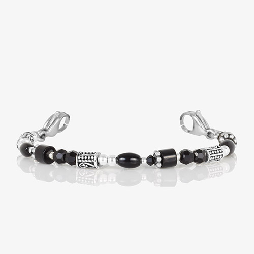 Close-up of the bracelet strand without the tag, showing alternating faceted black beads, silver spacers, and detailed silver cylinders for a bold, modern look.