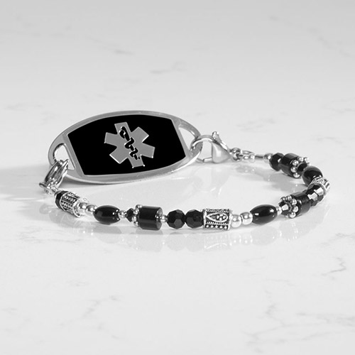 Full view of the Livi beaded medical ID bracelet in black and silver, featuring decorative metal beads and a black tag with silver medical symbol.
