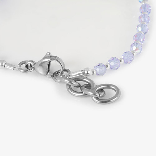 Close-up of the lobster clasp and extender chain, showing the beaded construction and silver hardware.