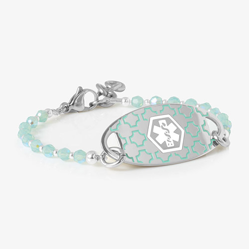 Medical ID bracelet with translucent sea-glass green beading and a silver ID tag featuring a white medical symbol on a geometric background.