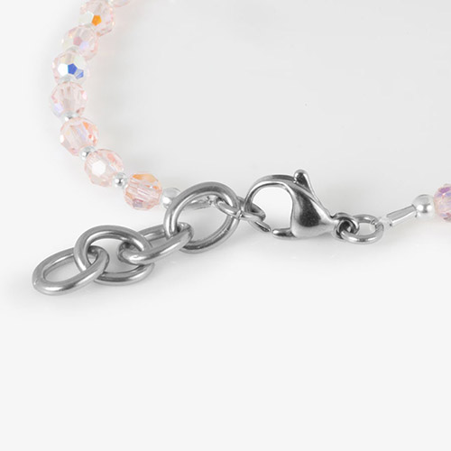 Detail of silver lobster clasp and extender chain on Dani SmartStretch bracelet with light pink beads.