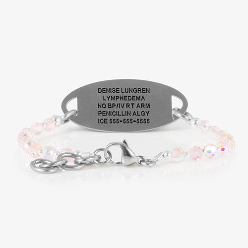 Silver medical alert tag with custom engraving and light pink faceted beaded bracelet.