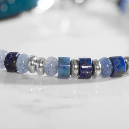 Close up of Blue and silver beaded medical ID bracelet on jewelry elastic with stainless steel lobster clasps and sapphire blue decorative med ID tag.