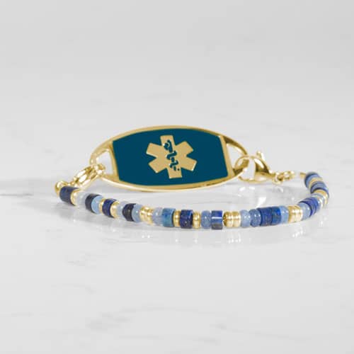 Blue and gold beaded medical ID bracelet on jewelry elastic with gold plated stainless steel lobster clasps and sapphire blue decorative med ID tag.