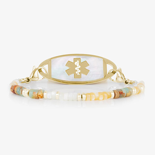 Willow beaded medical alert bracelet with earth-toned gemstone beads and a gold-tone tag with white mother-of-pearl inlay and matching gold medical symbol.