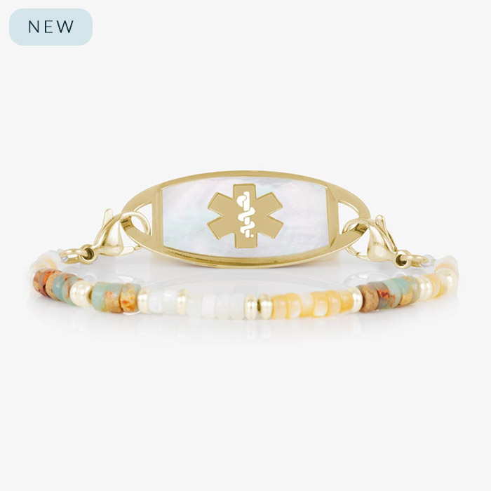 Willow beaded medical alert bracelet with earth-toned gemstone beads and a gold-tone tag with white mother-of-pearl inlay and matching gold medical symbol.