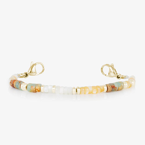 Close-up of the Willow interchangeable medical ID bracelet strand in a gold-tone finish. Features pale yellow, cream, and natural disc beads with gold-tone hardware and clasps, shown on a white background.