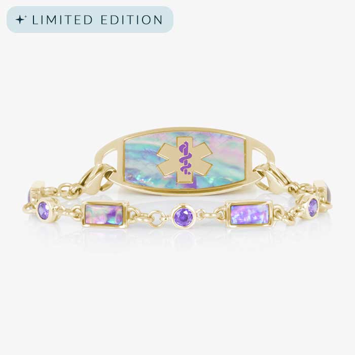 Gold medical alert bracelet with iridescent lilac abalone inlay and purple amethyst accent stones, featuring a purple medical ID symbol on the faceplate.
