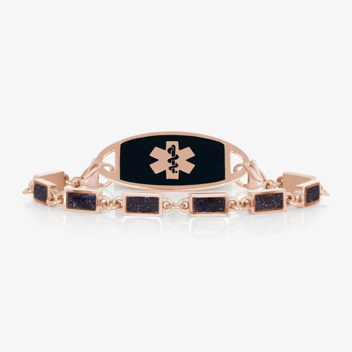 Rose gold-tone medical ID bracelet with a black inlay plaque and rectangular glitter-accent link bracelet.