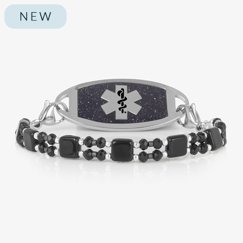Jett medical ID bracelet in silver with black and silver beads and square black tile accents, featuring a glittering blue medical ID tag with silver caduceus symbol.
