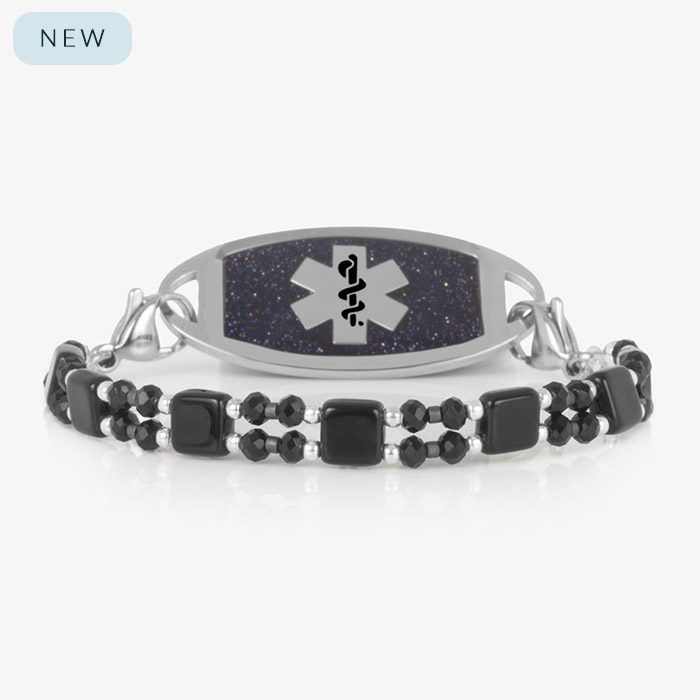 Jett medical ID bracelet in silver with black and silver beads and square black tile accents, featuring a glittering blue medical ID tag with silver caduceus symbol.
