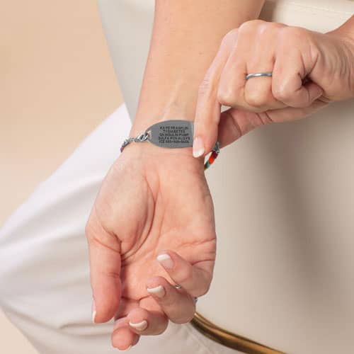 Woman showing custom laser engraved Silver medical ID tag