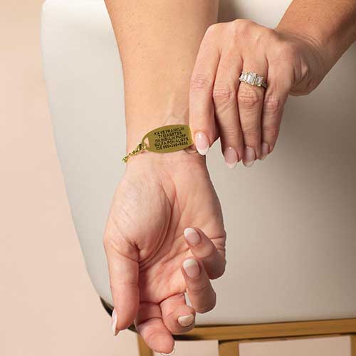 Woman displaying the custom, laser engraved, text on her medical ID.