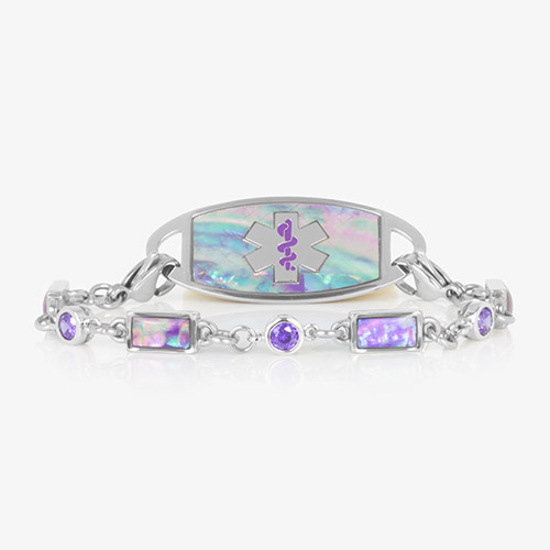 Image shows a silver medical alert bracelet featuring alternating lilac abalone and violet cubic zirconia inlays, paired with a coordinating ID tag engraved with a purple medical symbol.