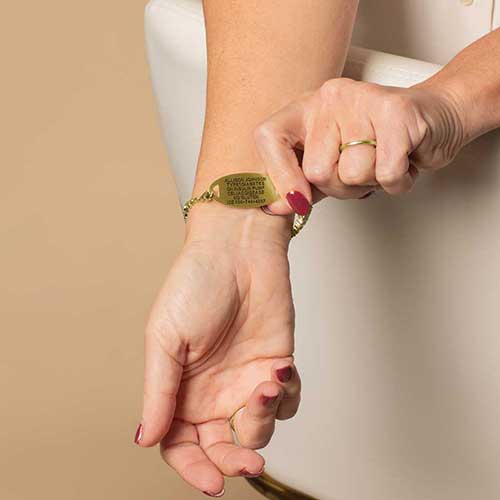 Woman displaying the custom, laser engraved, medical details on her ID.