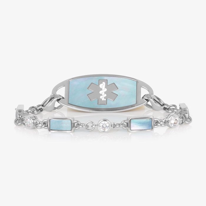 Silver medical ID bracelet with blue mother-of-pearl inlay tag and clear and iridescent rectangular gemstone accents, displayed on a white background.