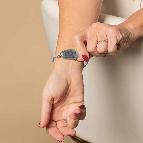 Woman displaying the custom, laser engraved, medical details.