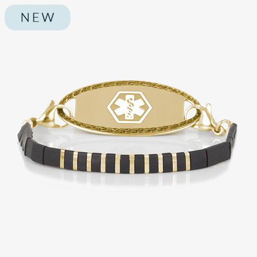 Gold medical ID bracelet with alternating black and gold tila beads and a polished gold ID tag featuring white medical symbol.
