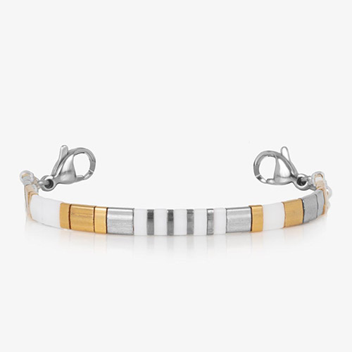 Stretch bracelet strand with alternating cube beads in white, silver, gold, and hematite tones.