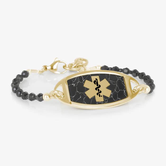 Gold medical ID bracelet with black beaded chain and marble inlay plaque, featuring a Star of Life emblem for stylish safety.
