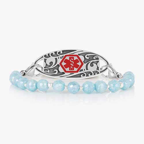 Silver medical ID bracelet with aquamarine faceted beads and silver accents, featuring a decorative silver ID tag with red caduceus.