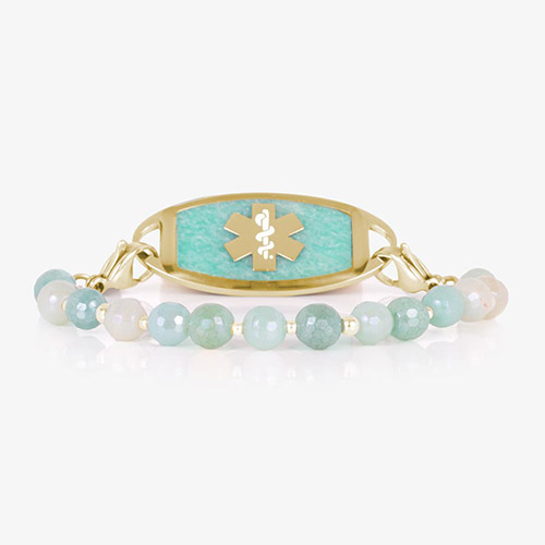 Interchangeable medical ID bracelet with aqua and cream faceted beads and gold accents, shown with a matching gold ID tag featuring a gold medical symbol on a textured amazonite inlay.