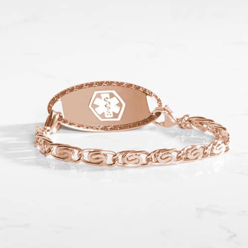Rose gold medical ID bracelet with decorative swirl links and engraved medical emblem, combining elegant style with safety.