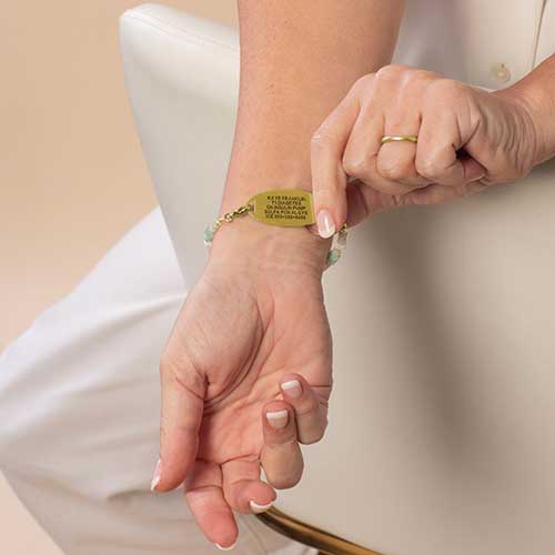 Woman displaying the custom, laser engraving on her Lauren's Hope medical ID bracelet.