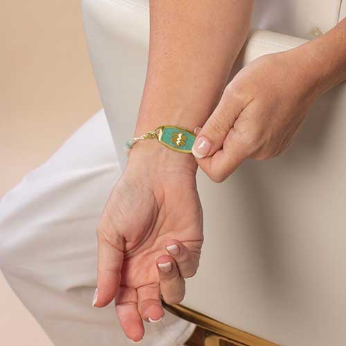 Woman wearing a custom, Amazonite inlaid medical ID Tag